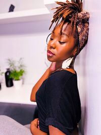 Portrait of young woman sitting at home