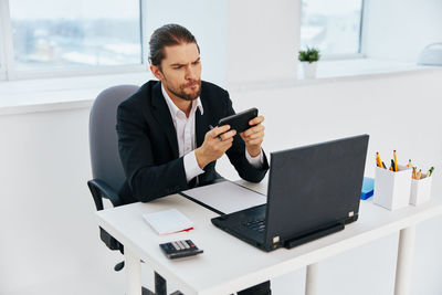 Businessman using mobile phone at office