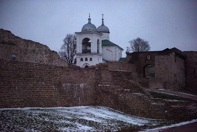 Historic building against sky during winter