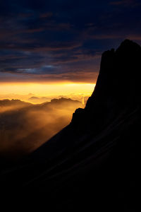 Scenic view of silhouette mountain against sky during sunset