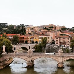 Bridge over river with buildings in background