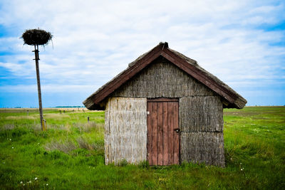 Built structure on field against sky