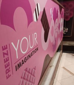 Close-up of text on pink store