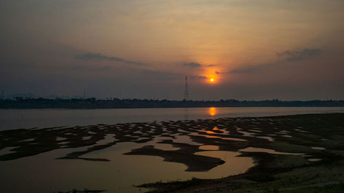 Scenic view of lake against sky during sunset