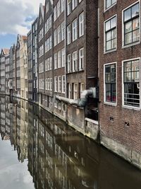 Canal amidst buildings in city