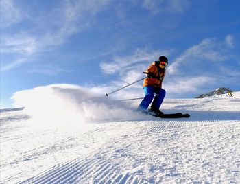 Full length of man skiing on snow against sky