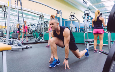 Full length of man exercising in gym