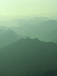 Scenic view of silhouette mountains against sky