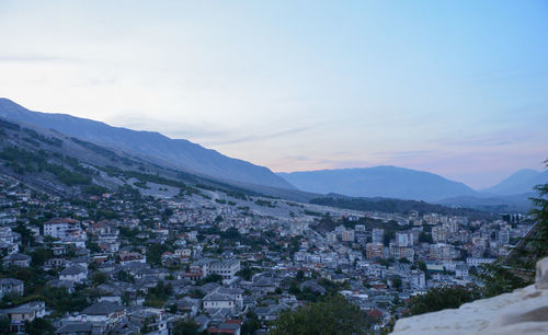 High angle view of townscape and mountains against sky