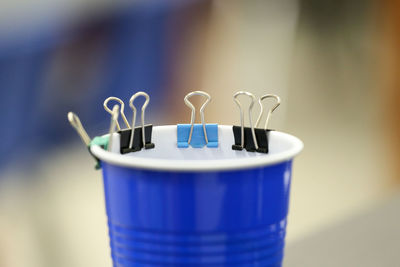 Close-up of paper binders on drinking glass