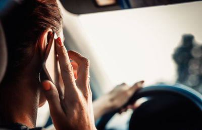 Close-up portrait of woman hand using mobile phone