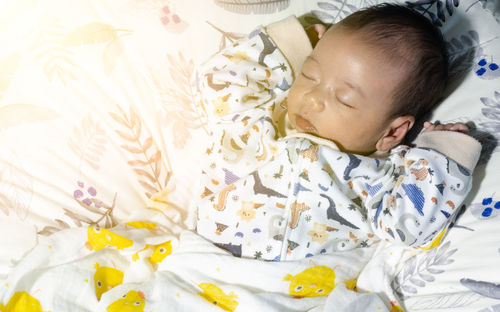 Cute boy sleeping in bed
