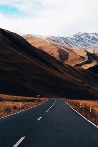 Road amidst landscape against sky