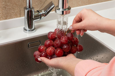 Cropped hand of person washing hands