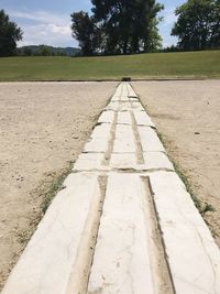 Surface level of footpath against sky