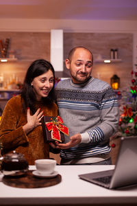 Happy friends on table at home