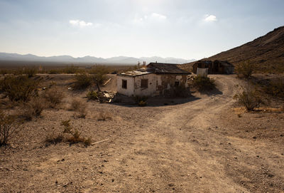 Houses on desert against sky