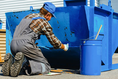 Man painting metal structure