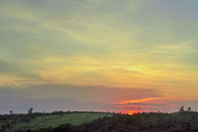 Scenic view of field against sky during sunset