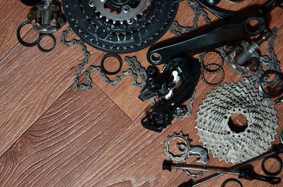 Directly above shot of bicycle chain and gear on table