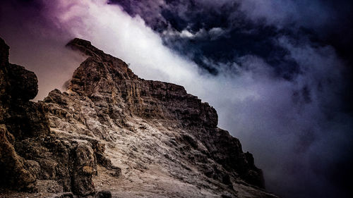 Low angle view of rock formation against sky