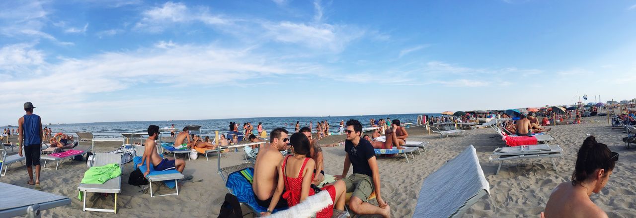 large group of people, sea, beach, person, horizon over water, leisure activity, lifestyles, water, sky, vacations, relaxation, men, shore, mixed age range, parasol, enjoyment, beach umbrella, summer, tourist