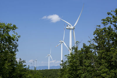 A valley of wind turbines in the tuscan countryside