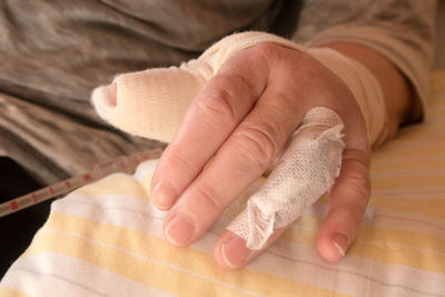 Midsection of man with bandage on hand