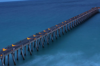 Scenic view of illuminated bridge over sea