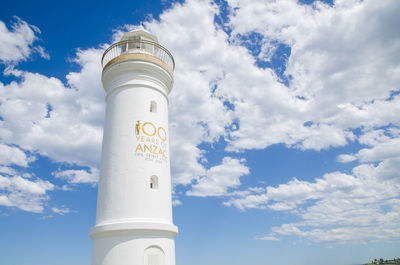 Low angle view of lighthouse against blue sky