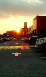 Cars on road in city during sunset