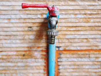 Close-up of faucet against wall