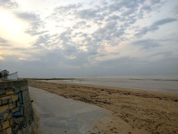 Scenic view of beach against sky during sunset