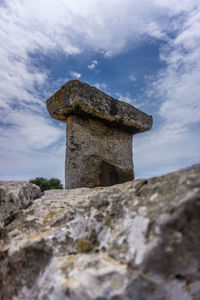 Low angle view of stone wall against sky