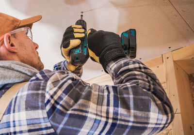 Low angle view of man working at site