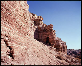 Rock formations on landscape against clear sky