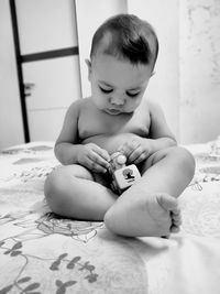 Cute baby girl sitting on bed