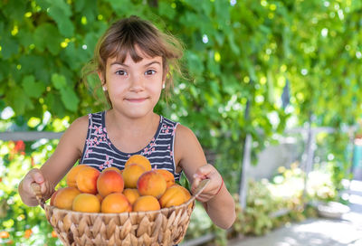 Portrait of woman picking fruit