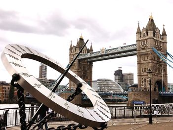 Low angle view of bridge against cloudy sky