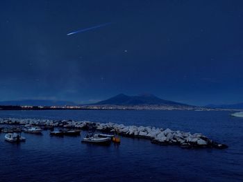 Scenic view of sea against clear sky at night