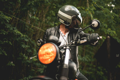 Man riding motorcycle outdoors