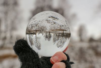 Close-up of hand holding crystal ball