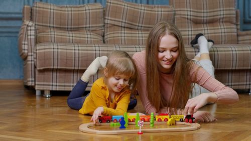 High angle view of mother playing with toys