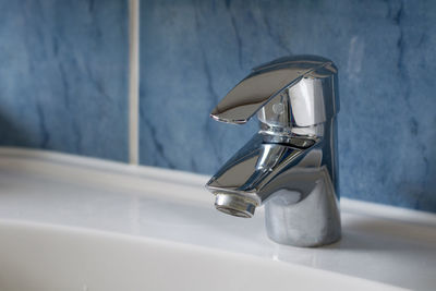 Close-up of faucet in bathroom