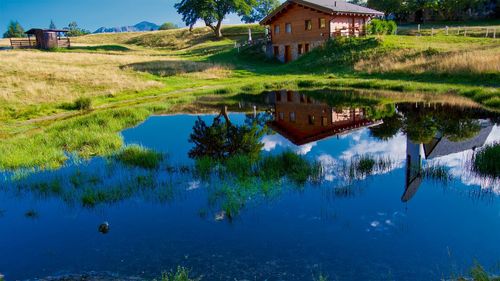 Scenic view of lake by building against sky