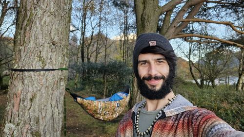 Portrait of young woman standing in forest