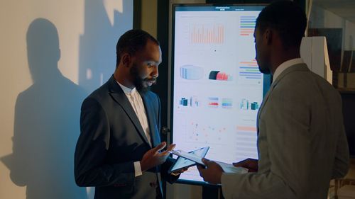 Side view of business colleagues working at office