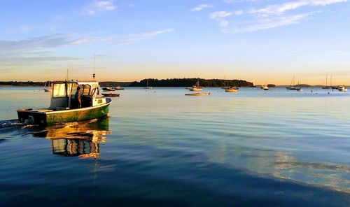 Boats in marina at sunset