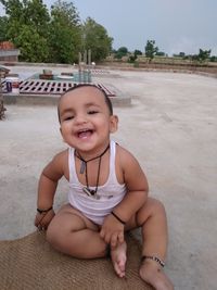 Portrait of cute girl sitting at beach