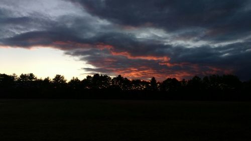 Silhouette of landscape against cloudy sky